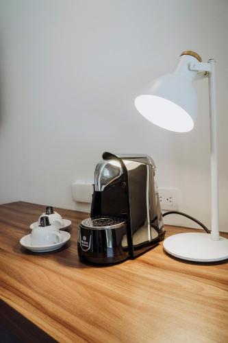 a toaster sitting on top of a wooden table at Novotel Medellin El Tesoro in Medellín