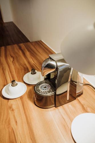 a phone sitting on top of a wooden table at Novotel Medellin El Tesoro in Medellín