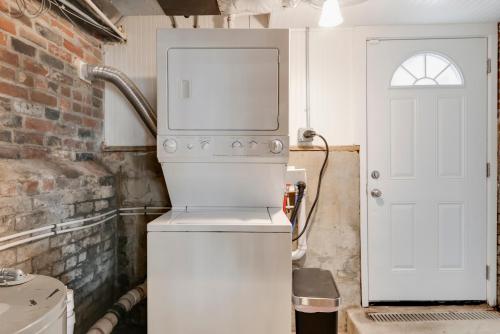 a white refrigerator with a microwave on top of it at Prime Location! Cozy Home in Church Hill/Shockoe in Richmond