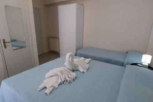a bed with a pile of white towels on it at Umberto I Nicosia in Nicosia