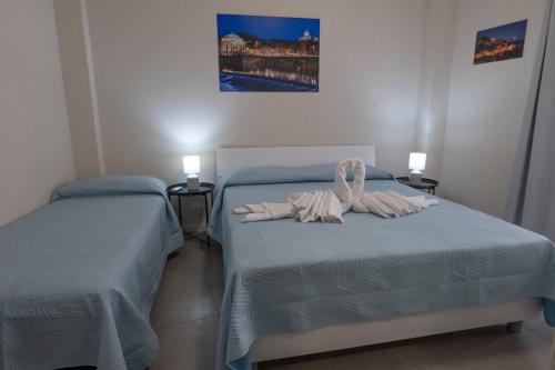 a bedroom with two beds with towels on them at Umberto I Nicosia in Nicosia