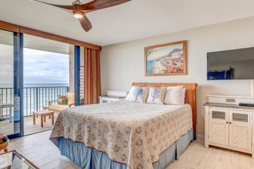 a bedroom with a bed and a balcony at Papakea A203 in Lahaina