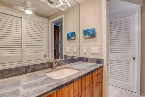 a bathroom with a sink and a mirror at Papakea A203 in Lahaina