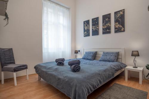 a bedroom with a bed with two pillows on it at Magnolia apartment in Zagreb
