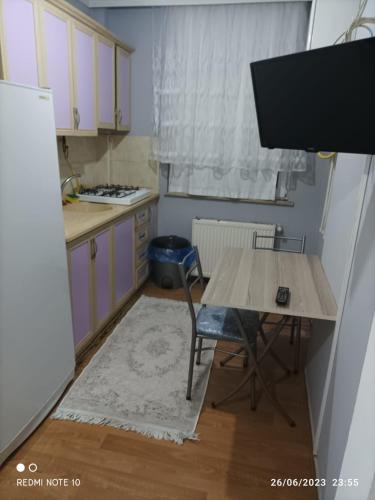 a small kitchen with a table and a table and a chair at Goldwinn turizm in Trabzon