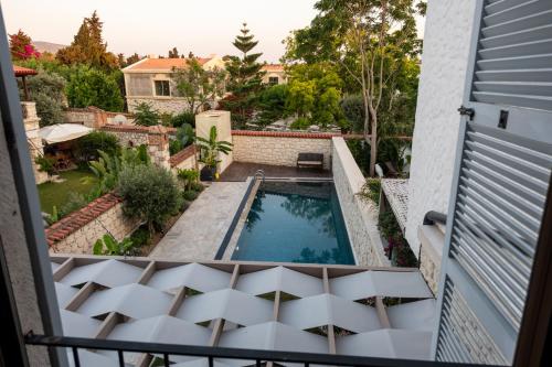 a view from the balcony of a house with a swimming pool at Zena Hotel Alaçatı Adults Only in Alacati