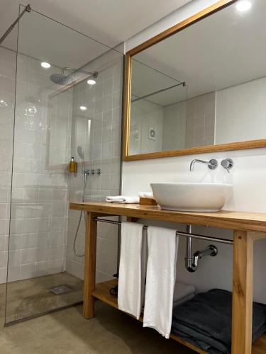 a bathroom with a sink and a mirror at CASAS DO LARANJO- Cottages & Infinity Pool by brugrani in Gaula