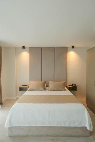 a bedroom with a large white bed with two pillows at THE DECK OTEL in Trabzon