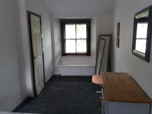 an empty hallway with a table and a window at NEWFIELD INN in Broughton in Furness