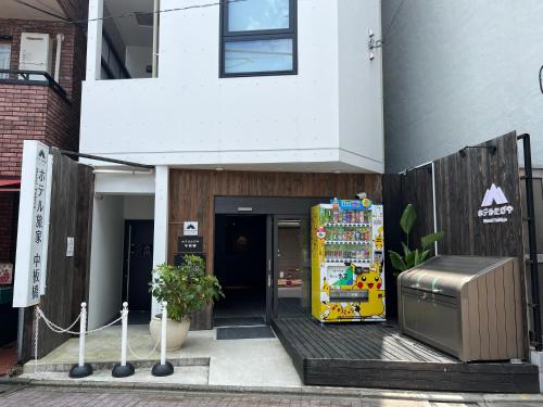 a vending machine in front of a building at Hotel Tabiya in Tokyo