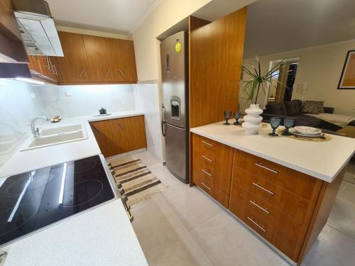 a kitchen with a sink and a refrigerator at Filoxenia Luxury Home Patras in Patra