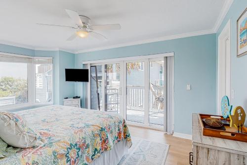 a bedroom with a bed and a ceiling fan at Ponce Inlet Villa in Ponce Inlet