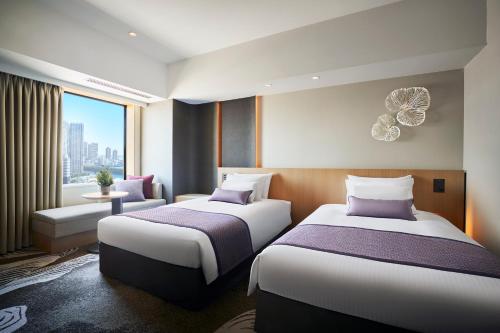 a hotel room with two beds and a window at Hotel JAL City Tokyo Toyosu in Tokyo