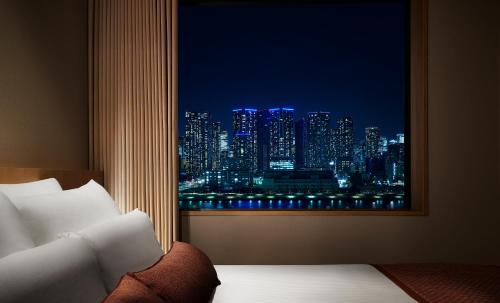 a room with a window with a view of a city at Hotel JAL City Tokyo Toyosu in Tokyo
