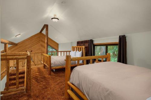 a bedroom with two twin beds and a staircase at Sky Serenity in Skykomish