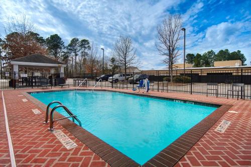 a swimming pool with blue water in a building at Candlewood Suites Columbia-Fort Jackson, an IHG Hotel in Columbia