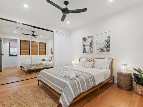 a bedroom with a bed and a ceiling fan at Breeze at Salt - Wheelchair Accessible with Heated Pool in Kingscliff