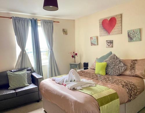 a bedroom with a bed with a heart on the wall at Lovely double room with private bathroom and Double room with shared toilet & PARKING FREE in Edinburgh