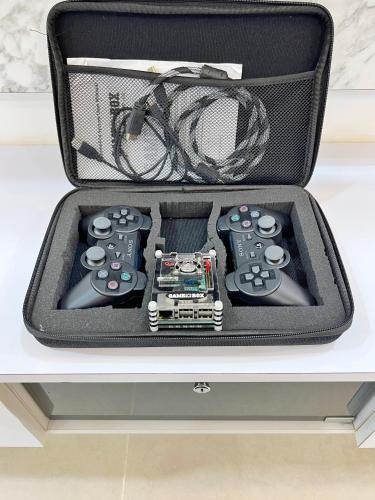 a suitcase with two video game controllers in it at RAPID Pelali Pengerang Homestay in Pengerang
