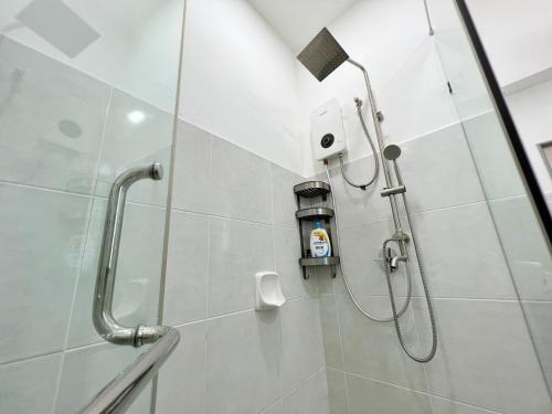 a shower with a shower head in a bathroom at RAPID Pelali Pengerang Homestay in Pengerang