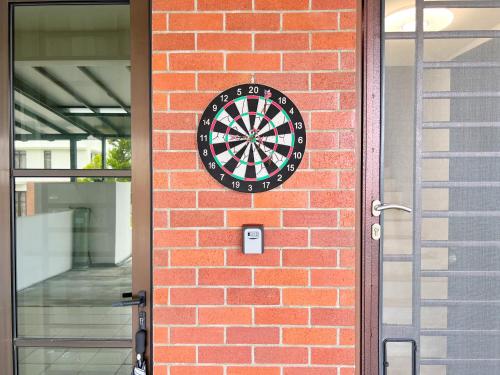 a dart board on the side of a brick wall at RAPID Pelali Pengerang Homestay in Pengerang