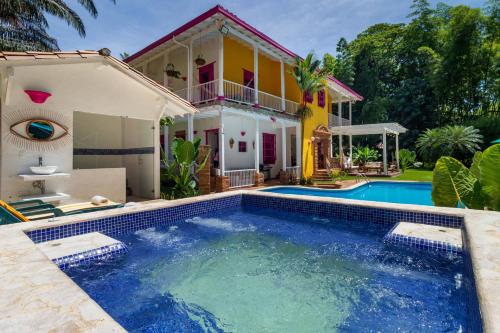a house with a swimming pool in front of a house at Casa Etnika in Jericó