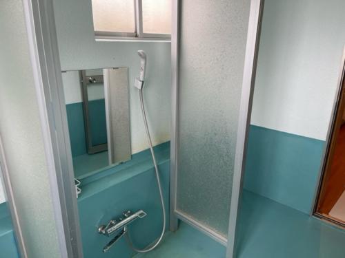 a bathroom with a shower with a mirror at 星の宿　Hoshi no Yado in Iiyama