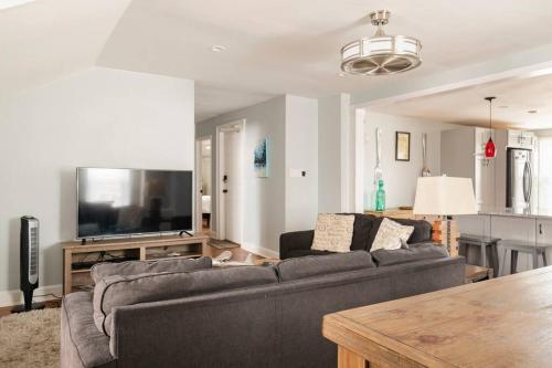 a living room with a couch and a flat screen tv at Historic Hagerstown Antietam Battlefield WhiteTail in Hagerstown