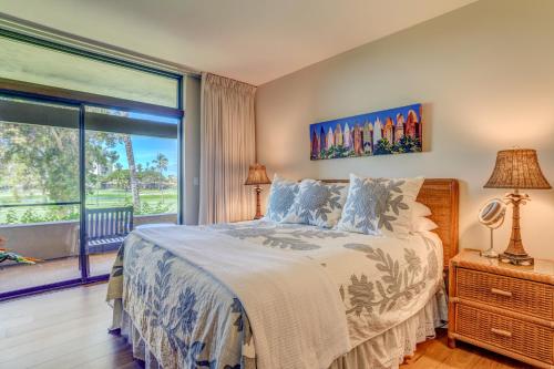 a bedroom with a bed and a large window at Kaanapali Royal D101 in Lahaina