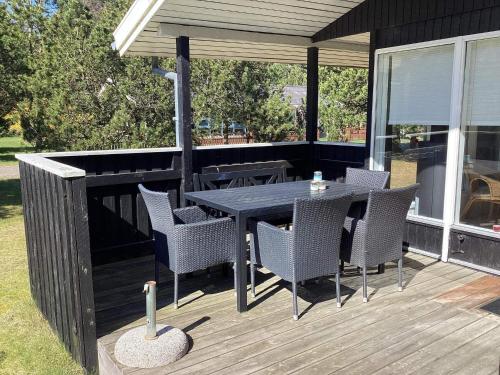 a patio with a table and chairs on a deck at 6 person holiday home in Hals-By Traum in Hals