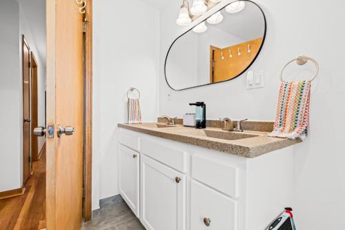 a bathroom with a sink and a mirror at Comfy Family-Friendly Getaway less than 15 mins to Downtown in Detroit