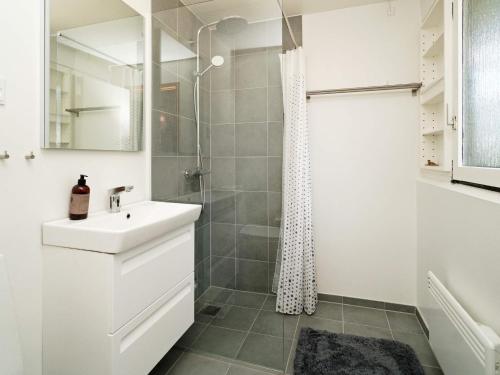a white bathroom with a sink and a shower at Holiday home Jægerspris XVII in Jægerspris