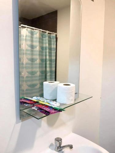 a bathroom with a glass shelf above a sink at Amani Grand Citygate 308 in Davao City