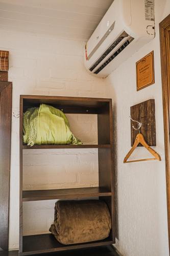 a room with two shelves in a room at Pousada Colina Verde in Garopaba