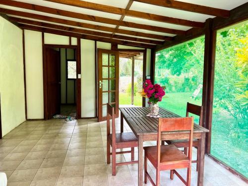 a dining room with a wooden table and chairs at Freshwater Plantation Farm Stay in Luganville