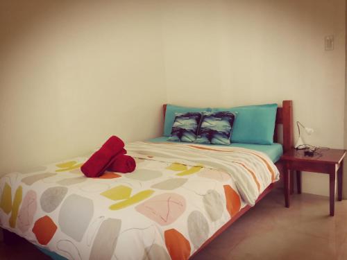 a bed with two pillows on it in a room at MoonViews Apartment in Panglao