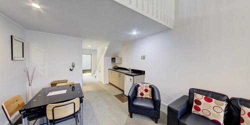 a living room with a couch and a table at Arista of Rotorua in Rotorua