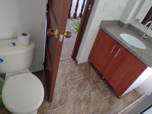 a bathroom with a toilet and a sink at Casa Hotel Palermo 49 in Bogotá
