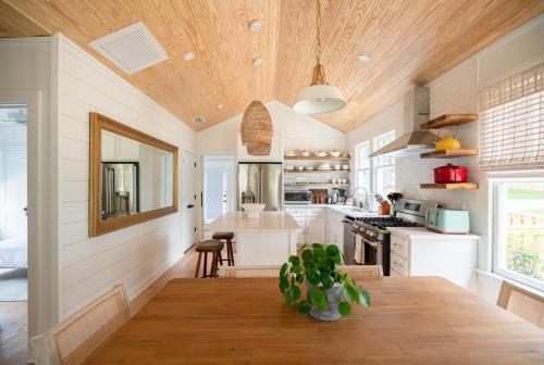 a kitchen with a wooden ceiling and a wooden table at 106 the Church St Collection with pool in Fairhope