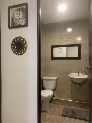 a bathroom with a toilet and a sink at Casa de vacaciones Santa Marta! in Santa Marta