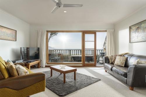 a living room with a couch and a tv at A Room With a View in Kaikoura