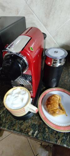 a cup of coffee and a plate of food on a counter at Departamento Alta Cordoba "Lautaro", con Pileta in Cordoba