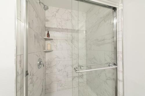 a bathroom with a shower with a glass door at Suite Dreams 2BR Parking Yale New Haven Lawn Club in New Haven