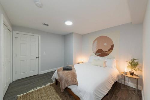 a bedroom with a large white bed and a white door at Suite Dreams 2BR Parking Yale New Haven Lawn Club in New Haven