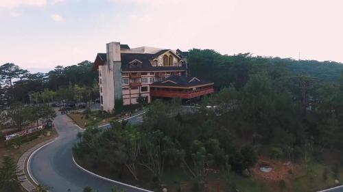 an aerial view of a building on a road at The Forest Lodge at Camp John Hay privately owned unit with parking 265 in Baguio