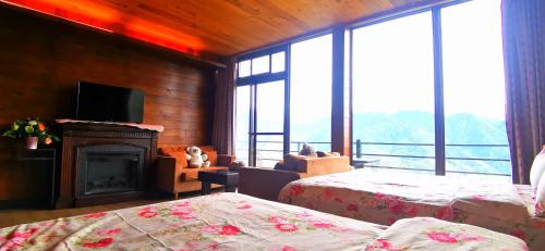 a room with two beds and a fireplace and a television at Villa Relax in Renai