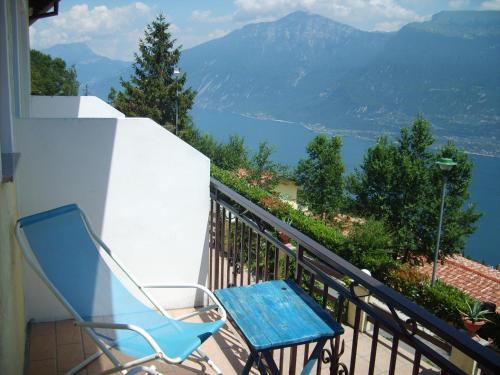 a blue chair sitting on a balcony with a view at Hotel Panorama e Residence in Tremosine Sul Garda