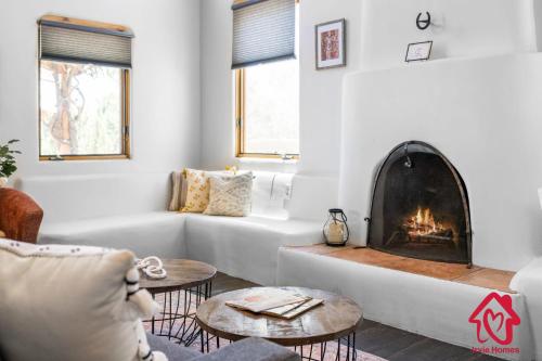 a living room with a couch and a fireplace at Hillside Haven Retreat - A Placitas Irvie Home in Santa Ana Pueblo