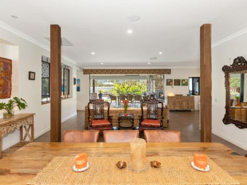 a dining room with a table and chairs at The Doggy Beach House - with Pool in Pottsville in Pottsville