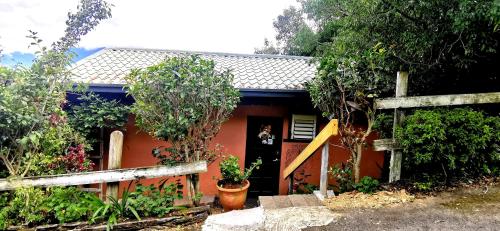 a small red house with a fence in front of it at Villa Relax in Renai